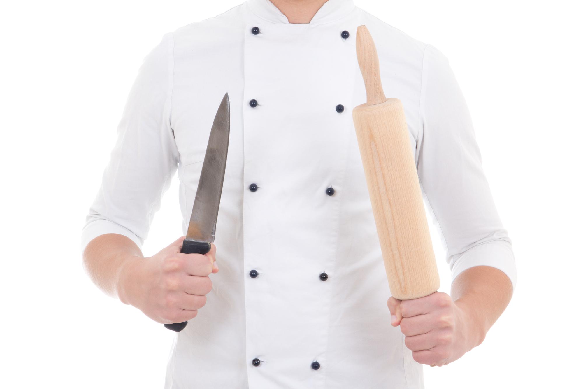 Instructor guiding student with knife skills